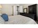 Main bedroom with large bed, black furniture, and neutral color palette at 16938 Scuba Crest St, Wimauma, FL 33598