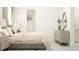 Inviting bedroom with a comfortable bed, dresser, nightstand, stylish decor, and a walk-in closet at 16969 Falling Waters Ct, Land O Lakes, FL 34638