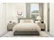 Comfortable bedroom with a gray upholstered bed, matching nightstands, lamps, and gray curtains at 16969 Falling Waters Ct, Land O Lakes, FL 34638