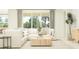 Bright living room with a comfortable white sofa, stylish decor, and a large window with natural light at 16969 Falling Waters Ct, Land O Lakes, FL 34638