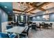Elegant meeting room with coffered ceilings, chandeliers, large windows, and comfortable seating for gatherings at 16969 Falling Waters Ct, Land O Lakes, FL 34638