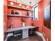 Inviting office nook with built-in desk, floating shelves, unique decor, and a window offering natural light at 16969 Falling Waters Ct, Land O Lakes, FL 34638