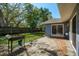 Fenced backyard with mature trees and patio, perfect for outdoor entertaining at 1721 Sutton Pl, Dunedin, FL 34698