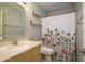 Bathroom with decorative shower curtain and updated vanity at 1721 Sutton Pl, Dunedin, FL 34698