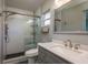 Updated bathroom featuring a glass enclosed shower and modern vanity at 1721 Sutton Pl, Dunedin, FL 34698