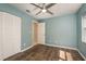 Bedroom with wood floors, a ceiling fan, closet, and natural light from the window at 1721 Sutton Pl, Dunedin, FL 34698