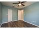 Bedroom with wood look tile floors and a ceiling fan at 1721 Sutton Pl, Dunedin, FL 34698