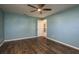 Bedroom with wood look tile floors and a ceiling fan at 1721 Sutton Pl, Dunedin, FL 34698