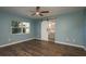 Spacious bedroom with ceiling fan and sliding barn door to the bathroom at 1721 Sutton Pl, Dunedin, FL 34698