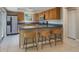Bright kitchen features stainless steel appliances and breakfast bar seating at 1721 Sutton Pl, Dunedin, FL 34698