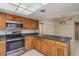 Bright kitchen features stainless steel appliances, tile floors and dark countertops at 1721 Sutton Pl, Dunedin, FL 34698