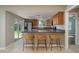 Kitchen boasts breakfast bar, tile floor, ample cabinets and stainless steel appliances at 1721 Sutton Pl, Dunedin, FL 34698