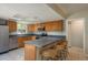 Bright kitchen features stainless steel appliances and breakfast bar seating at 1721 Sutton Pl, Dunedin, FL 34698