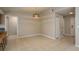 Spacious living room with tile flooring, modern lighting, closet and view to entry way at 1721 Sutton Pl, Dunedin, FL 34698