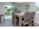 Bright dining area featuring a large wooden table, seating for six, and sliding glass doors at 1812 1St St, Indian Rocks Beach, FL 33785