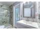 Bathroom featuring glass shower, vanity and decorative mosaic tiles at 1915 Fellsway Ct, Wesley Chapel, FL 33543