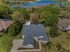 A high angle aerial view showcases a residential neighborhood with a lake, lush greenery, and homes at 19719 Prince Benjamin Dr, Lutz, FL 33549