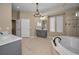 Bright bathroom featuring double vanity, soaking tub, and tiled shower stall with natural light at 19719 Prince Benjamin Dr, Lutz, FL 33549