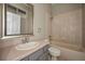 Bathroom with single sink, tile shower and bathtub, neutral color palette at 19719 Prince Benjamin Dr, Lutz, FL 33549