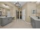Primary bathroom featuring separate vanities and a closet at 19719 Prince Benjamin Dr, Lutz, FL 33549