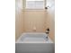 Clean bathroom features a shower and tub combo with tile surround at 19719 Prince Benjamin Dr, Lutz, FL 33549