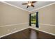 Spacious bedroom with warm color palette, fan, hardwood floors, and bright window at 19719 Prince Benjamin Dr, Lutz, FL 33549