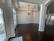 Dining space with dark wood floors, elegant lighting fixture, and natural light at 19719 Prince Benjamin Dr, Lutz, FL 33549