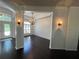 Dining area showcasing dark wood floors, plantation shutters, and decorative wall sconces at 19719 Prince Benjamin Dr, Lutz, FL 33549
