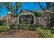 Community entrance featuring a distinguished sign with stone accents and manicured landscaping at 19719 Prince Benjamin Dr, Lutz, FL 33549