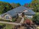 Aerial view of the lovely single-story home, showcasing the roof, landscaping, and surrounding trees at 19719 Prince Benjamin Dr, Lutz, FL 33549