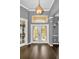 Elegant foyer with hardwood floors, decorative lighting, and a view of the front door at 19719 Prince Benjamin Dr, Lutz, FL 33549