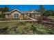 Charming single-story home with stone accents, lush landscaping, and a well-manicured lawn at 19719 Prince Benjamin Dr, Lutz, FL 33549
