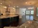 Modern kitchen with granite countertops, stainless steel appliances, and open to living area at 19719 Prince Benjamin Dr, Lutz, FL 33549