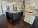 Modern kitchen with granite countertops, stainless appliances, and a large center island at 19719 Prince Benjamin Dr, Lutz, FL 33549