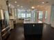 Spacious kitchen featuring a large island, stainless steel appliances, and custom cabinetry at 19719 Prince Benjamin Dr, Lutz, FL 33549