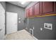 Laundry room with tile flooring, built in cabinets, and utility sink at 19719 Prince Benjamin Dr, Lutz, FL 33549