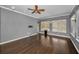 A well-lit living room with dark hardwood floors and neutral gray walls at 19719 Prince Benjamin Dr, Lutz, FL 33549