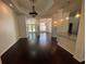 Elegant living area with hardwood floors, tray ceilings, and decorative lighting fixtures at 19719 Prince Benjamin Dr, Lutz, FL 33549