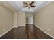 Spacious primary bedroom with trey ceiling, hardwood floors, and a ceiling fan at 19719 Prince Benjamin Dr, Lutz, FL 33549