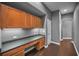 Home office with built-in desk, plenty of cabinetry, and hardwood flooring at 19719 Prince Benjamin Dr, Lutz, FL 33549