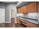 Spacious office with built-in desk and overhead cabinets overlooks entry to bedroom suite at 19719 Prince Benjamin Dr, Lutz, FL 33549