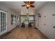A covered patio showcasing brick flooring, a ceiling fan, and access to the outdoor space and backyard at 19719 Prince Benjamin Dr, Lutz, FL 33549