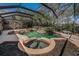 The uniquely designed pool area, screened-in, features a spa, rock accents, and lush landscaping at 19719 Prince Benjamin Dr, Lutz, FL 33549