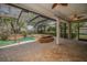 Screened-in pool area boasting a uniquely designed pool and spa, with lush landscaping and ample deck space at 19719 Prince Benjamin Dr, Lutz, FL 33549