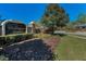 Well manicured entrance to Wellington Manor community with sign, stone pillars, and iron fencing at 19719 Prince Benjamin Dr, Lutz, FL 33549