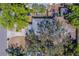 Overhead view of a home featuring a mature tree, driveway, and surrounding foliage at 2340 Kingston S St, St Petersburg, FL 33711