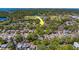 An aerial view showing tree coverage, this property's proximity to the road, and the area's lush parks at 2340 Kingston S St, St Petersburg, FL 33711