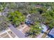 Aerial view captures the home's setting amidst mature trees, street access, and neighborhood context at 2340 Kingston S St, St Petersburg, FL 33711