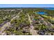A high-angle view of a quiet residential neighborhood with tree-lined streets and nearby waterways at 2340 Kingston S St, St Petersburg, FL 33711
