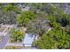 Aerial view showcases the home's position with mature trees, street presence, and surrounding neighborhood at 2340 Kingston S St, St Petersburg, FL 33711
